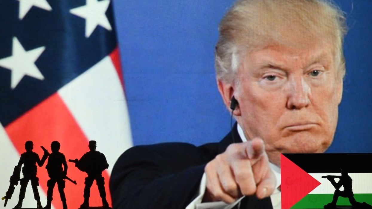 Silhouettes of soldiers stand in front of a computer screen displaying an image of President Donald Trump, alongside a Palestinian flag, on Feb. 05, 2025. 