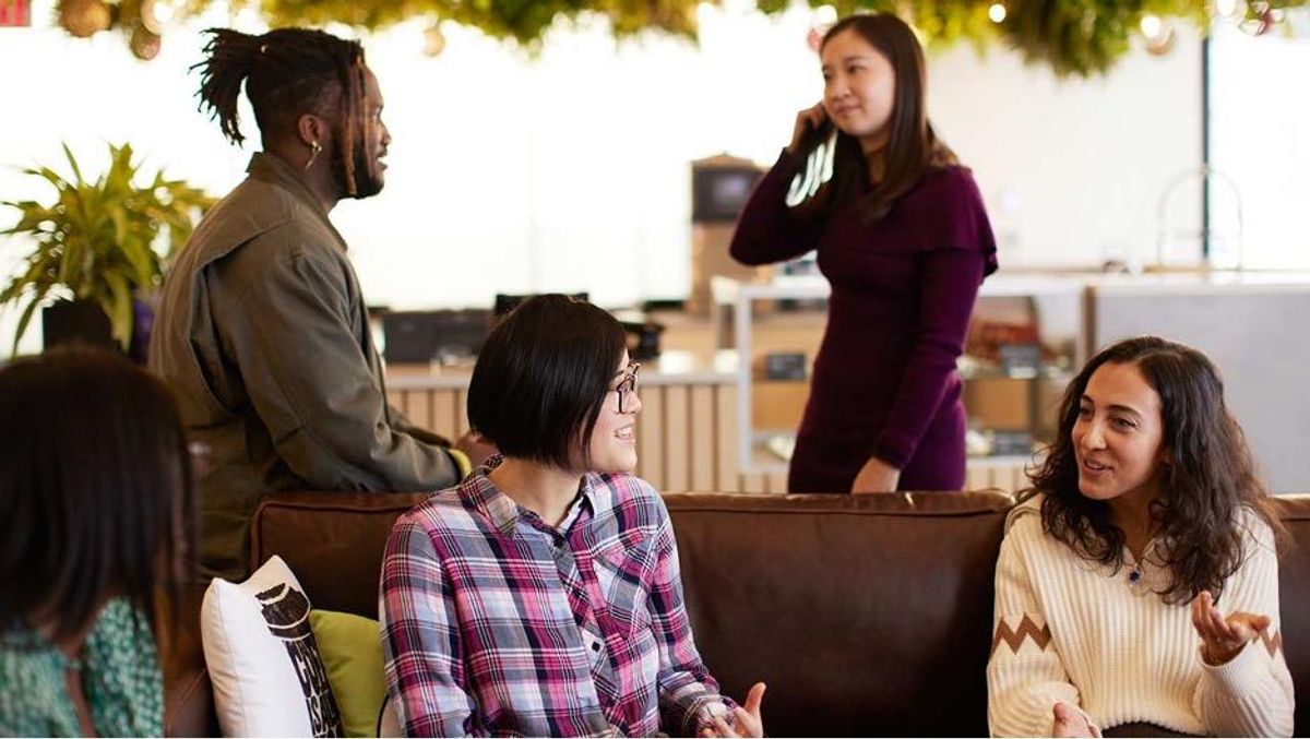 Small group of people gathered socially, most of whom are pictured smiling