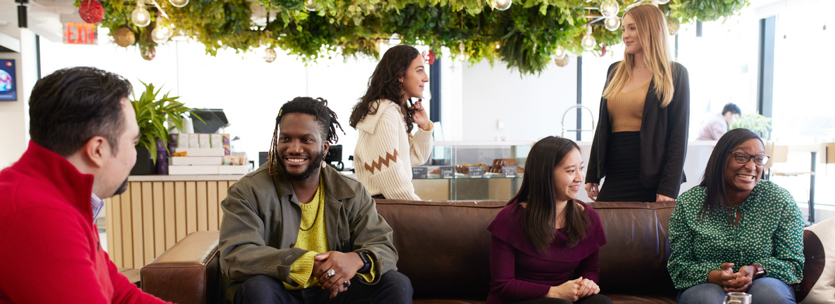 Small group of people gathered socially, most of whom are pictured smiling