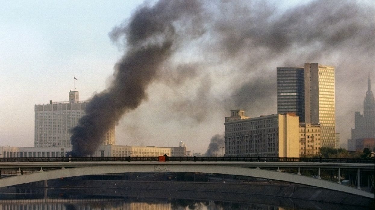 Smoke rises from the White House parliament building as Yeltsinist troops storm the Russian parliament October 4, 1993.