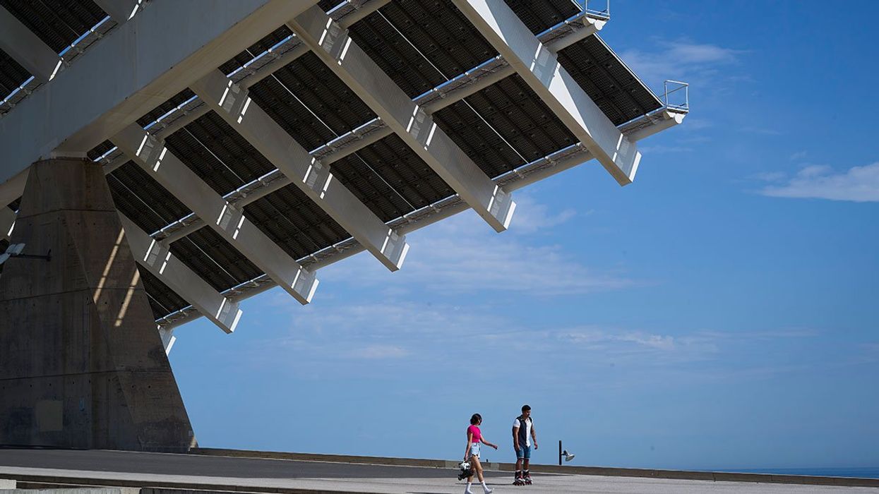 Solar panels and two people walking under them
