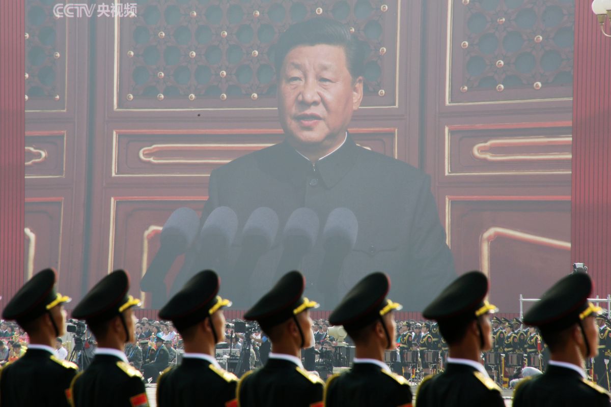 Soldiers of People's Liberation Army (PLA) are seen before a giant screen as Chinese President Xi Jinping speaks at the military parade marking the 70th founding anniversary of People's Republic of China