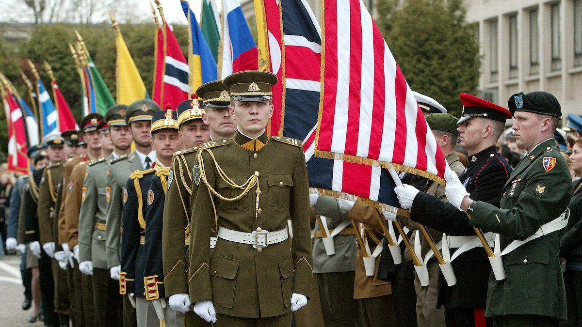 Soldiers of the seven newest NATO members parade during a ceremony marking the expansion of NATO's membership from 19 countries to 26 at the alliance headquarters in Brussels April 2, 2004. NATO foreign ministers participated in an event marking the formal accession of the seven newest members, Bulgaria, Estonia Latvia, Lithuania, Romania, Slovakia and Slonevia. 