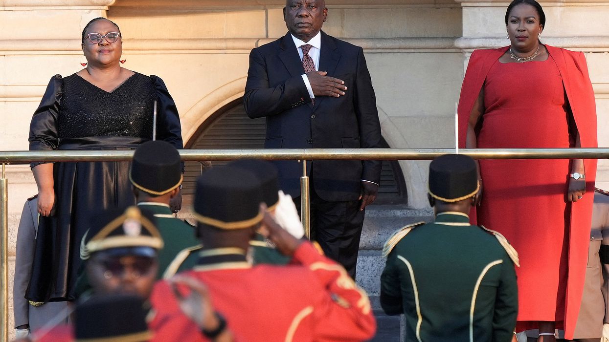 South African president Cyril Ramaphosa takes the national salute below a statue of former president Nelson Mandela at the Cape Town City Hall, ahead of his State Of The Nation (SONA) address in Cape Town, South Africa February 6, 2025.