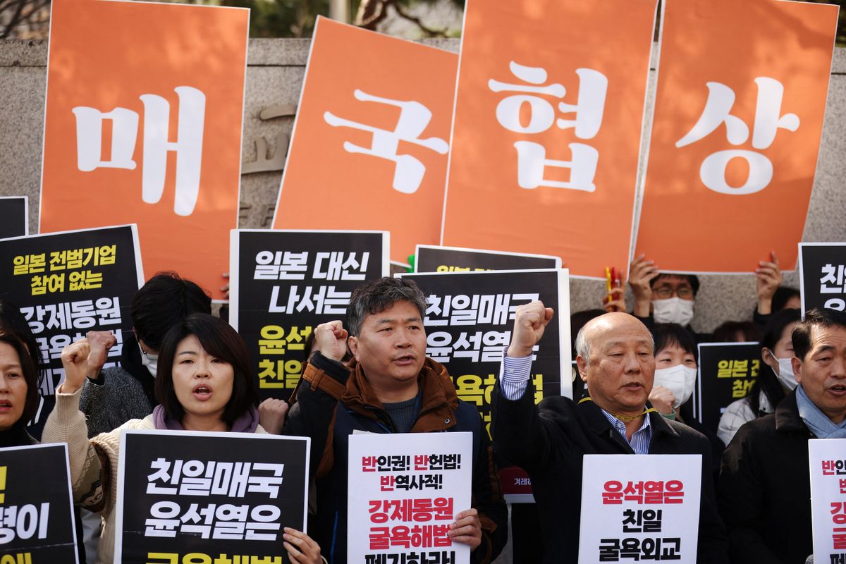 South Korean activists attend a protest denouncing a plan to resolve a dispute over compensating people forced to work under Japan's 1910-1945 occupation of Korea, in Seoul, South Korea, on Monday. 
