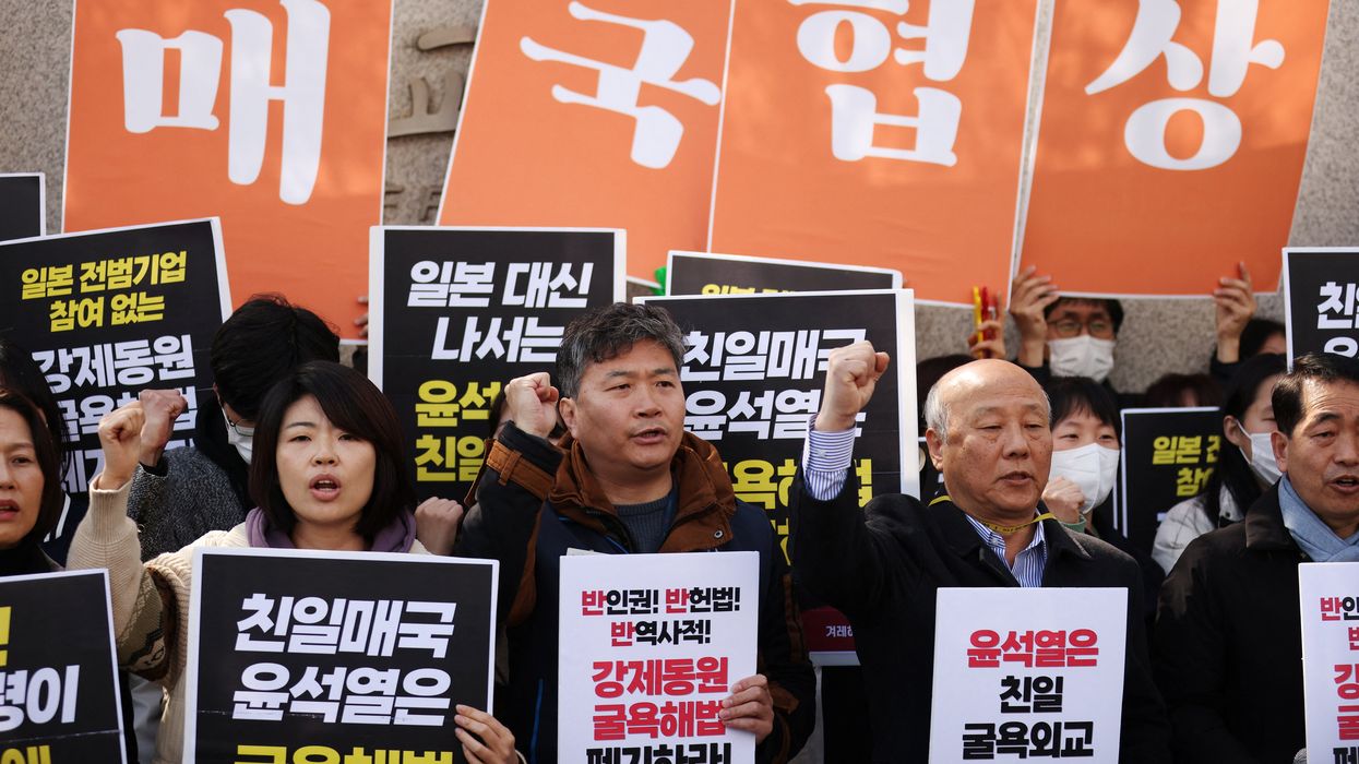 South Korean activists attend a protest denouncing a plan to resolve a dispute over compensating people forced to work under Japan's 1910-1945 occupation of Korea, in Seoul, South Korea, on Monday.