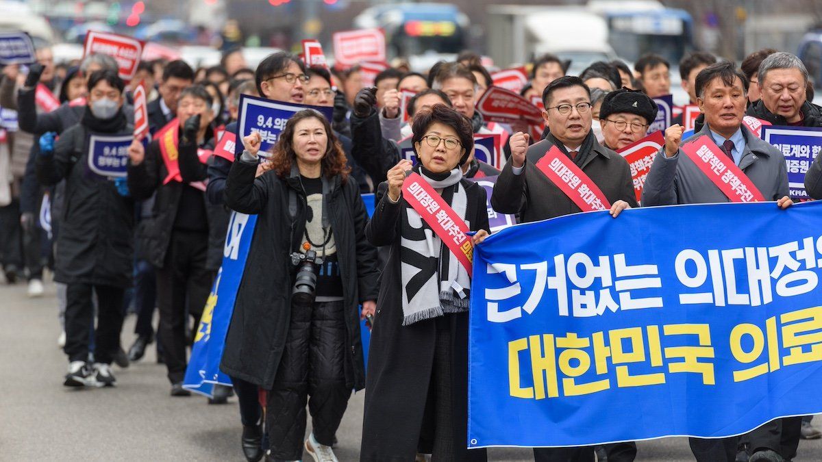 South Korean doctors march towards the Presidential Office while holding a banner during the protest. South Korea has raised its public health alert to the highest level, authorities announced on February 23, saying health services were in crisis after thousands of doctors resigned over proposed medical reforms.