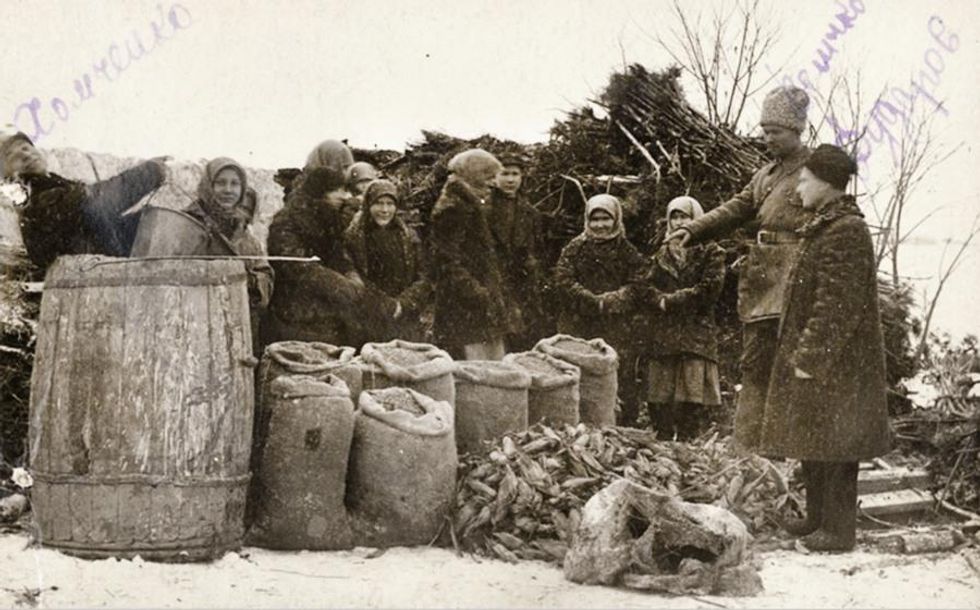 Soviet guards take crops from Ukrainian farmers in Odessa, 1932.