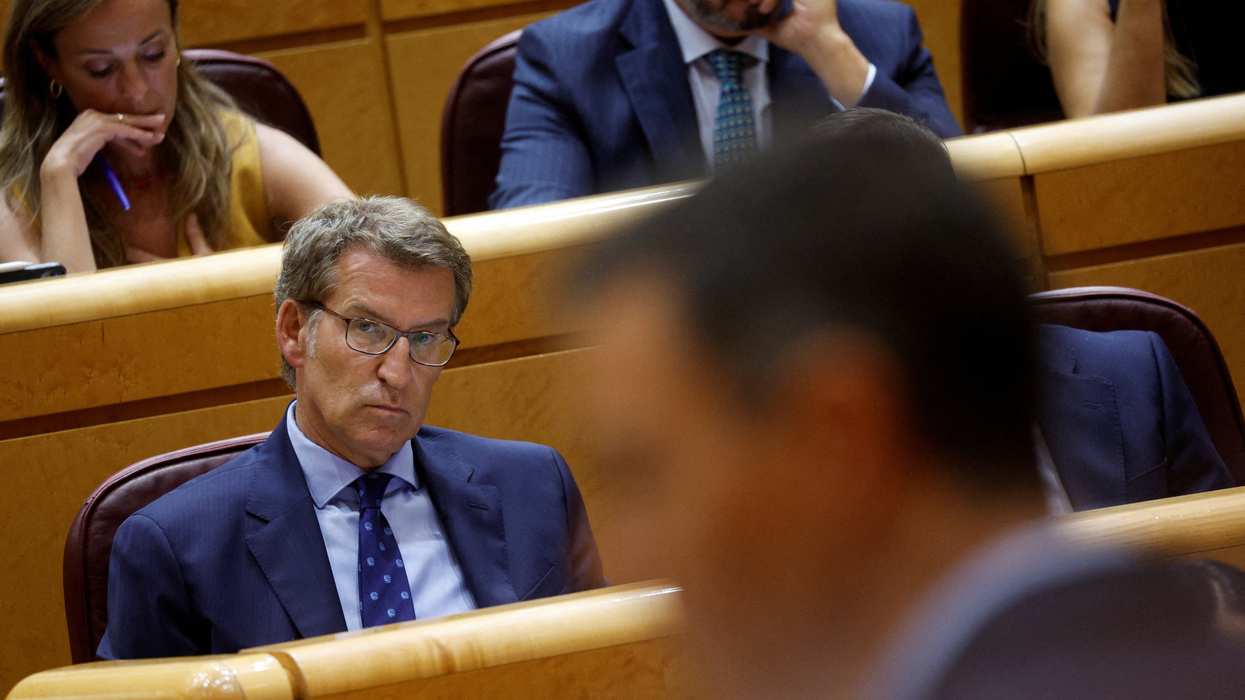 Spain's opposition People's Party leader Alberto Nunez Feijoo listens to PM Pedro Sanchez speak during a session at the Senate in Madrid.