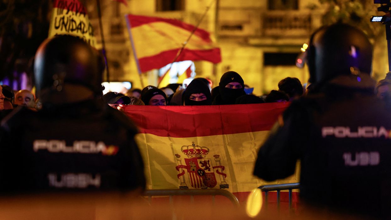 Spanish riot police officers stand guard during a protest, following acting Prime Minister Pedro Sanchez's negotiations for granting an amnesty to people involved with Catalonia's failed 2017 independence bid, in Madrid, Spain, November 7, 2023.