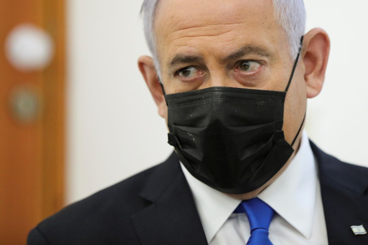sraeli Prime Minister Benjamin Netanyahu, wearing a face mask, looks as his corruption trial resumes, at Jerusalem's District Court April 5, 2021