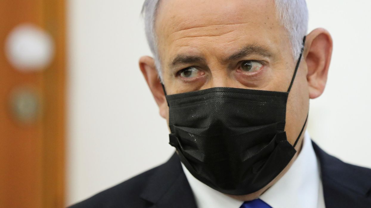 sraeli Prime Minister Benjamin Netanyahu, wearing a face mask, looks as his corruption trial resumes, at Jerusalem's District Court April 5, 2021