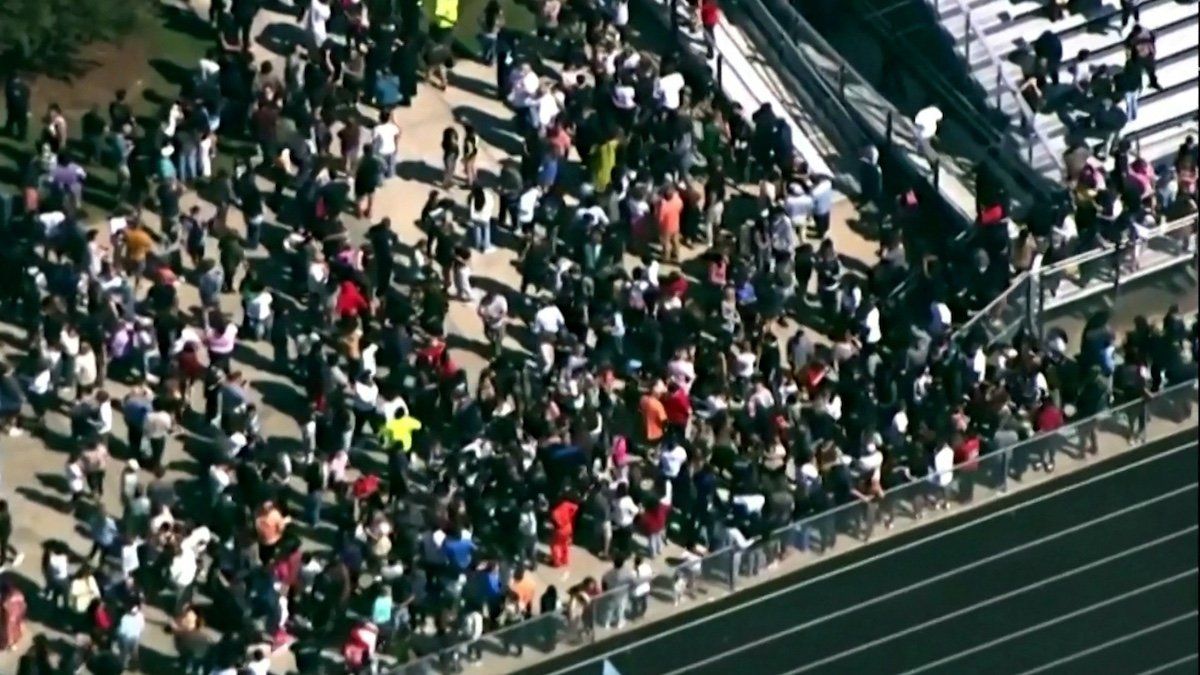 ​Students and staff gather next to the football field after law enforcement officers responded to a fatal shooting at Apalachee High School in a still image from aerial video in Winder, Georgia, U.S. September 4, 2024. 