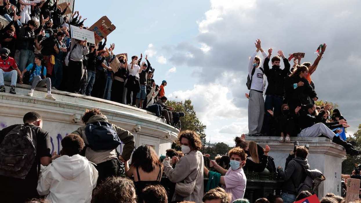 Students stand on the July Column during a high school and college student protest at Place de la Bastille in Paris, Ile-de-France, France, on October 8, 2026.