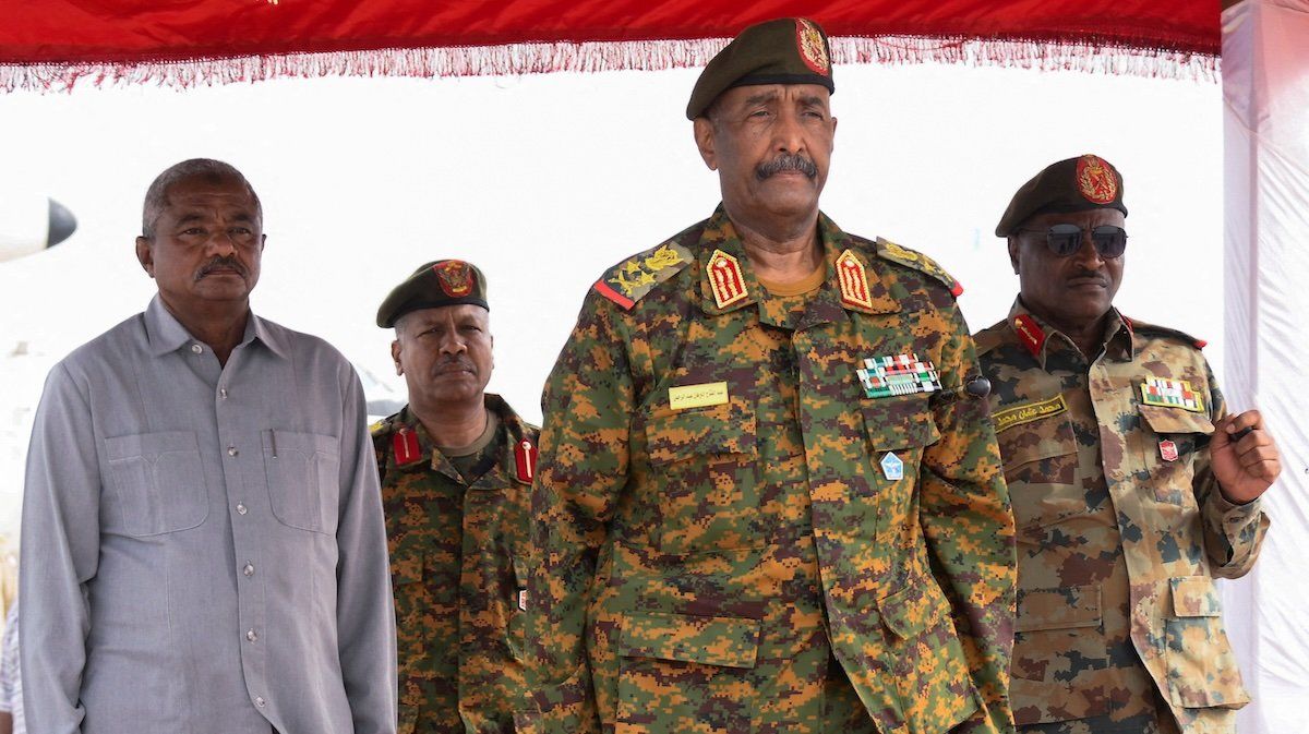 Sudan's General Abdel Fattah al-Burhan listens to the national anthem after landing in the military airport in the city of Port Sudan, Sudan, August 27, 2023.