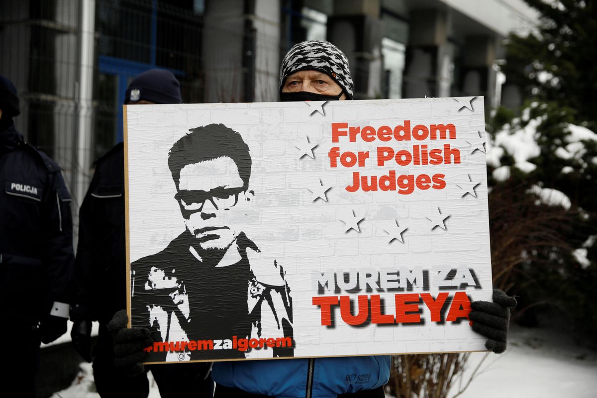  Supporter of Judge Igor Tuleya stands with a banner in front of the National Public Prosecutor's Office in Warsaw, Poland January 20, 2021.