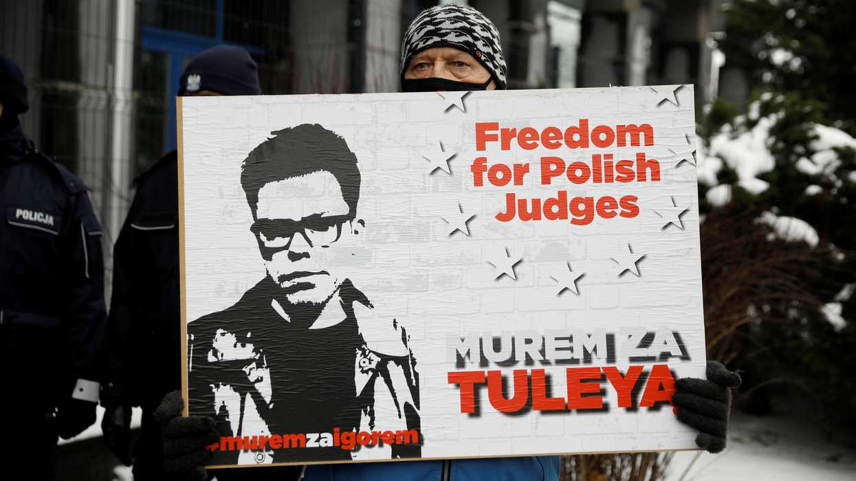 Supporter of Judge Igor Tuleya stands with a banner in front of the National Public Prosecutor's Office in Warsaw, Poland January 20, 2021.