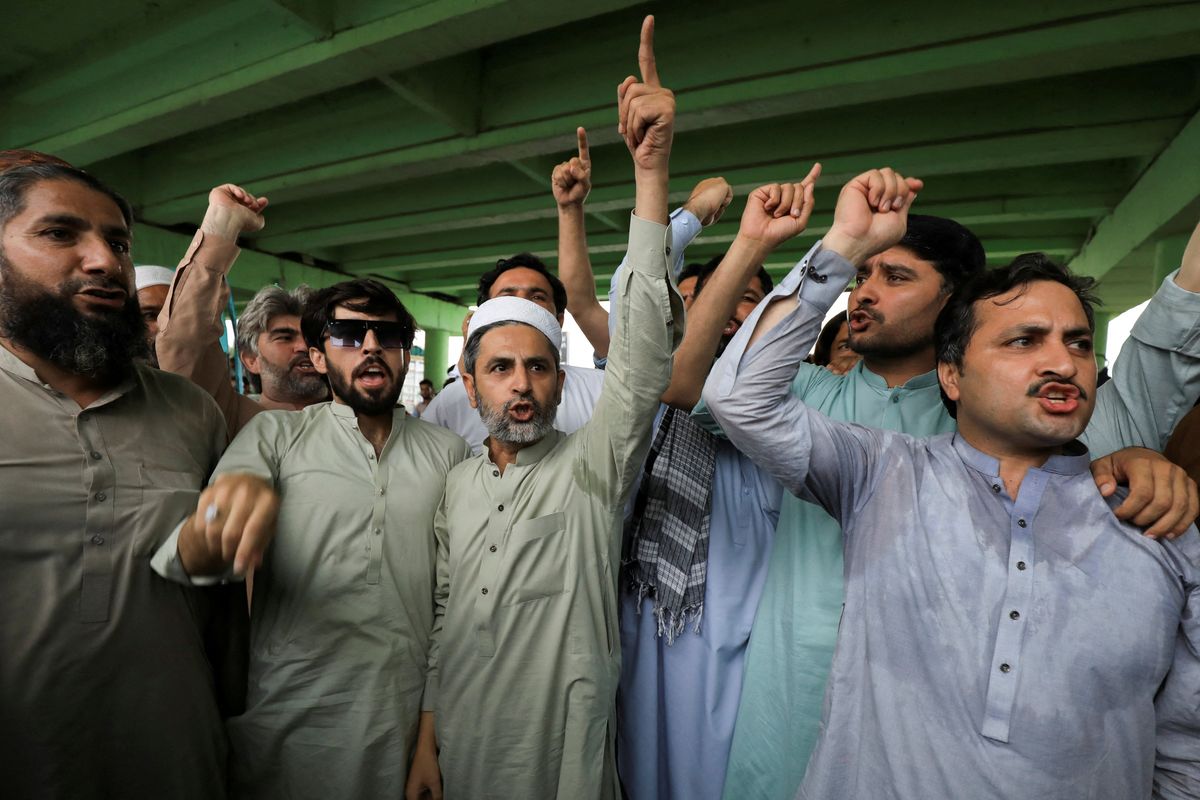 ​Supporters chant slogans as they gather for a protest following the arrest of Pakistan's former Prime Minister Imran Khan, in Peshawar, Pakistan.