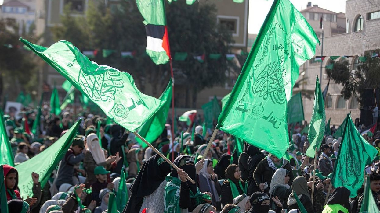 Supporters of Hamas wave their green flags during a celebration marking the 35th anniversary of the founding of Hamas in Gaza City in December 2022.