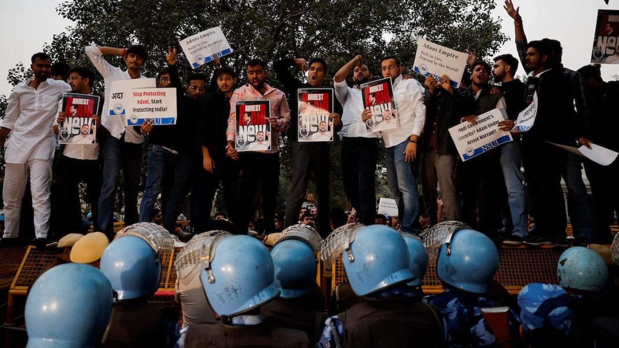 Supporters of India's main opposition Congress party hold placards during a protest against Indian billionaire Gautam Adani, after he was indicted in New York over his role in an alleged multibillion-dollar bribery and fraud scheme, in New Delhi, India, November 21, 2024.