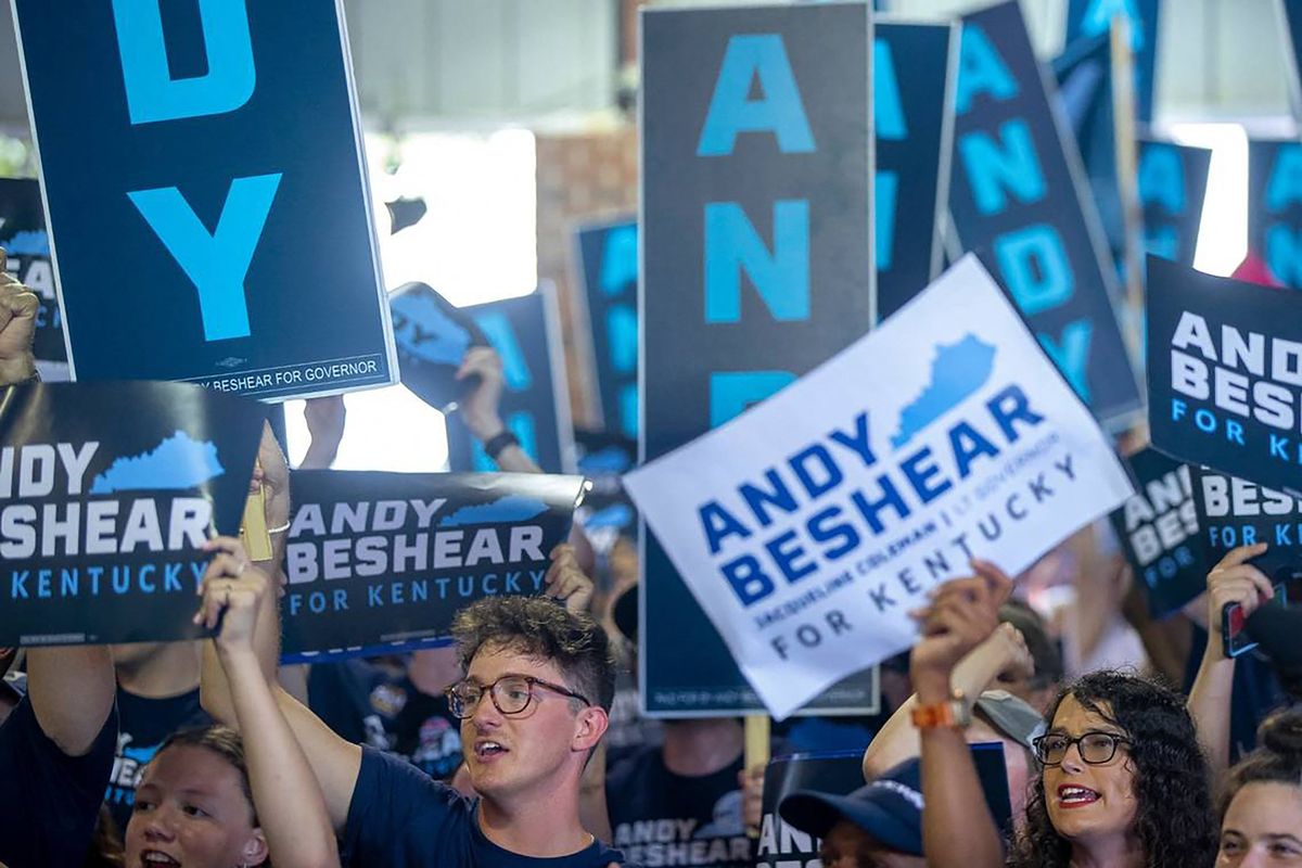 Supporters of Kentucky Gov. Andy Beshear hold signs and cheer during the annual St. Jerome Fancy Farm Picnic in Fancy Farm, Kentucky, on Aug. 5, 2023.