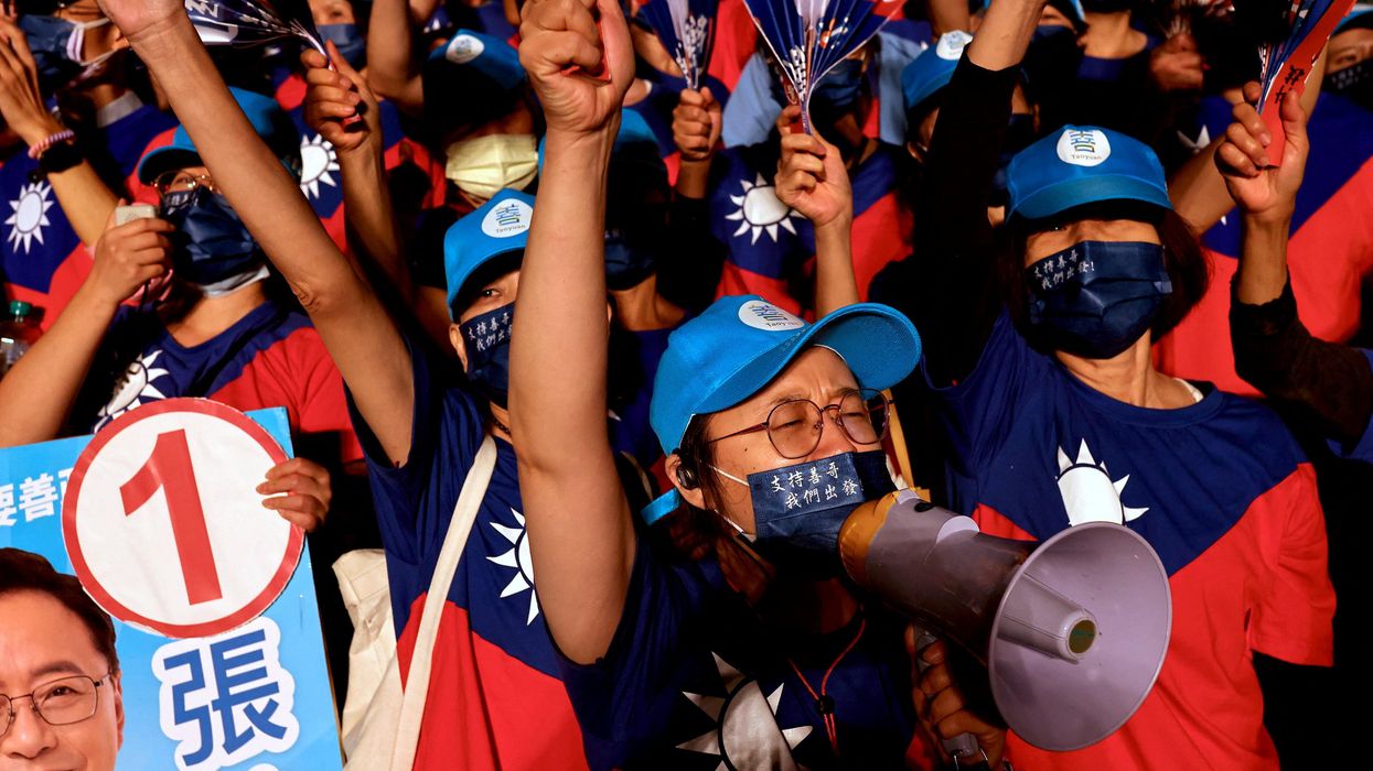 Supporters of opposition party KMT wearing t-shirts with the Taiwan flag at an election rally in Taoyuan.