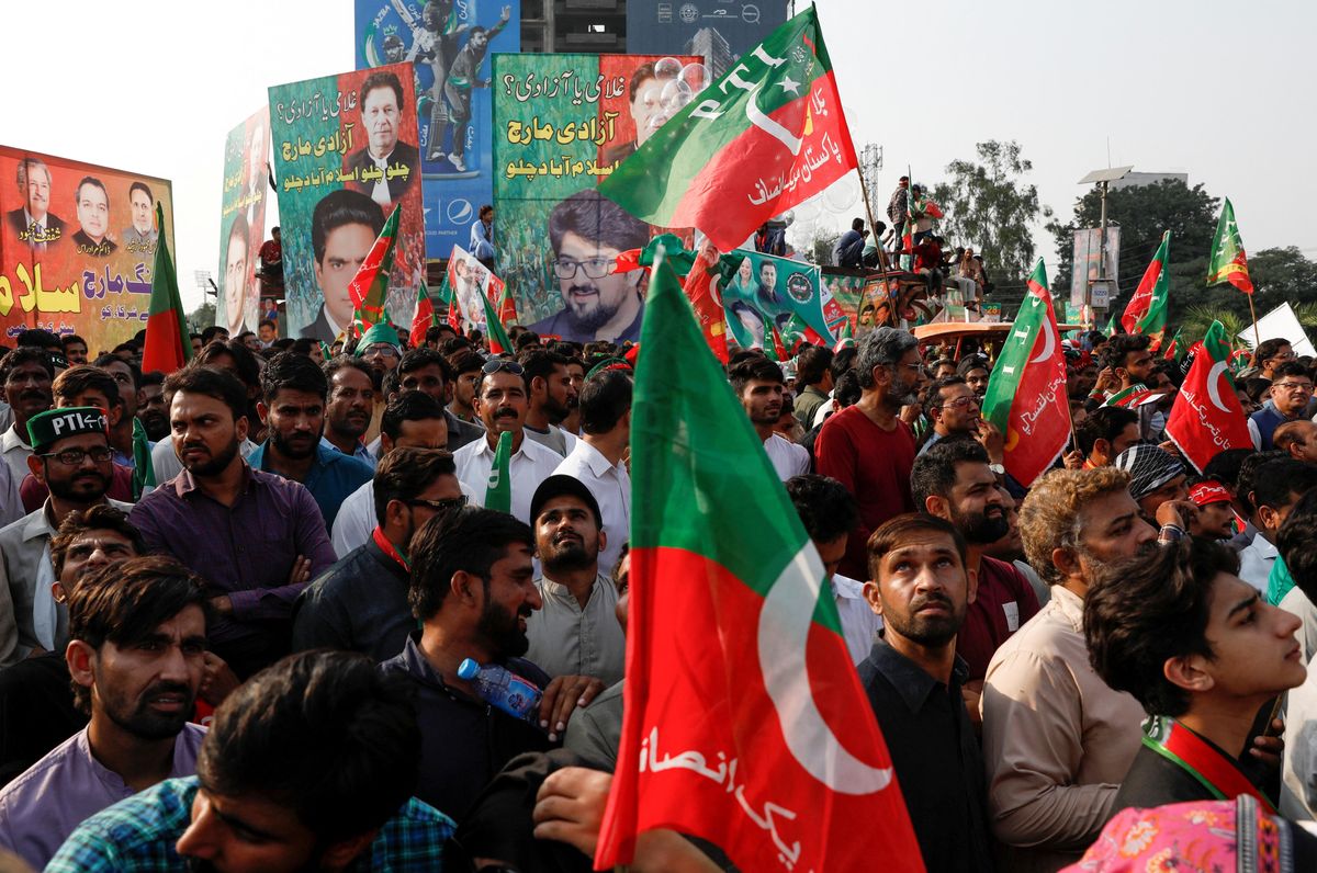 Supporters of Pakistan's ousted former PM Imran Khan listen to his Long March speech in Lahore.