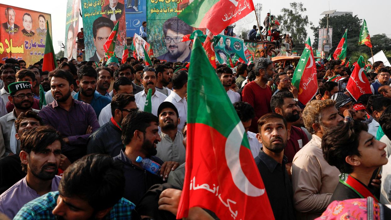 Supporters of Pakistan's ousted former PM Imran Khan listen to his Long March speech in Lahore.
