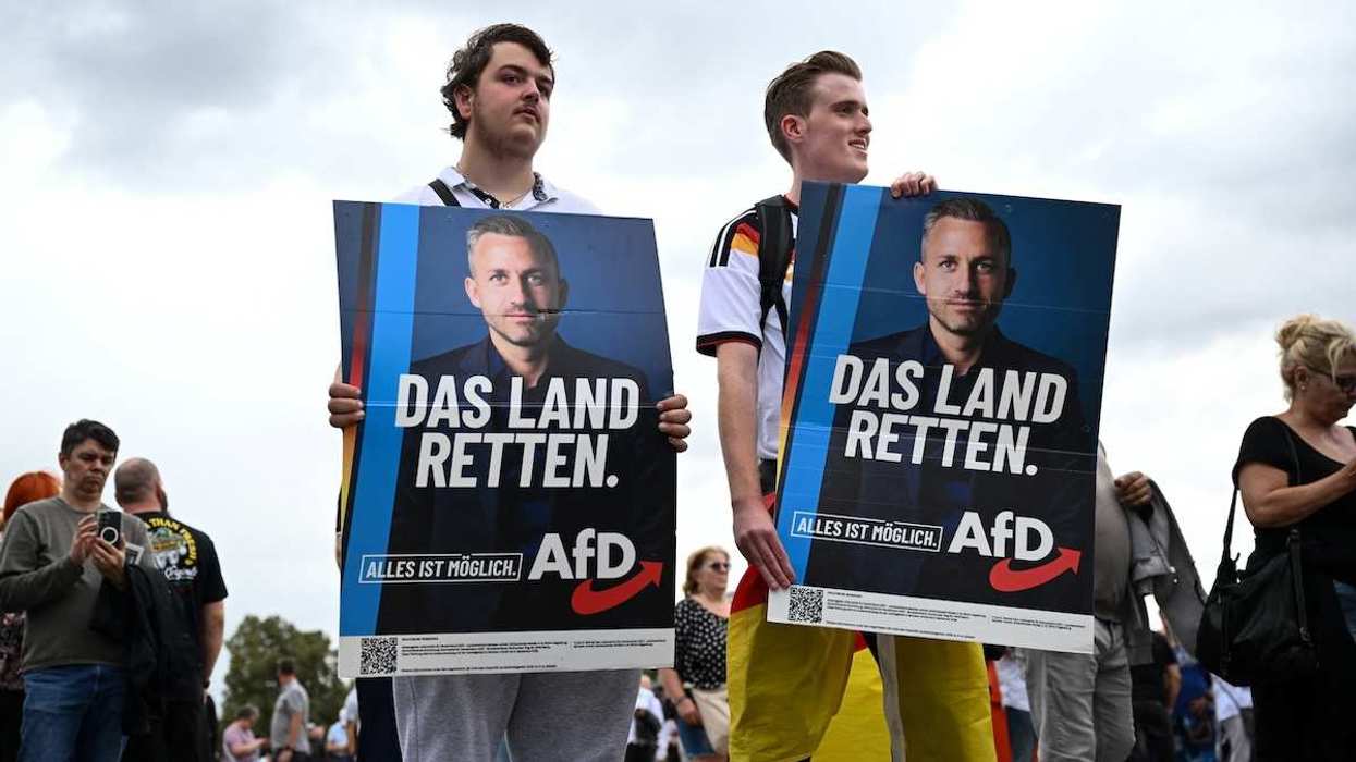 Supporters of the Alternative for Germany (AfD) party hold placards as they attend AfD top candidate Ulrich Siegmund's campaign event ahead of the upcoming Saxony-Anhalt state elections in Magdeburg, Germany.