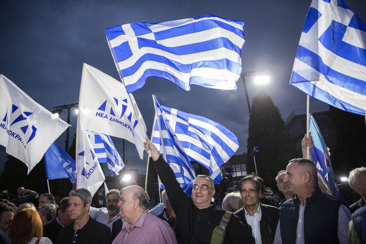 Supporters of the conservative New Democracy party celebrate their election victory in Athens.