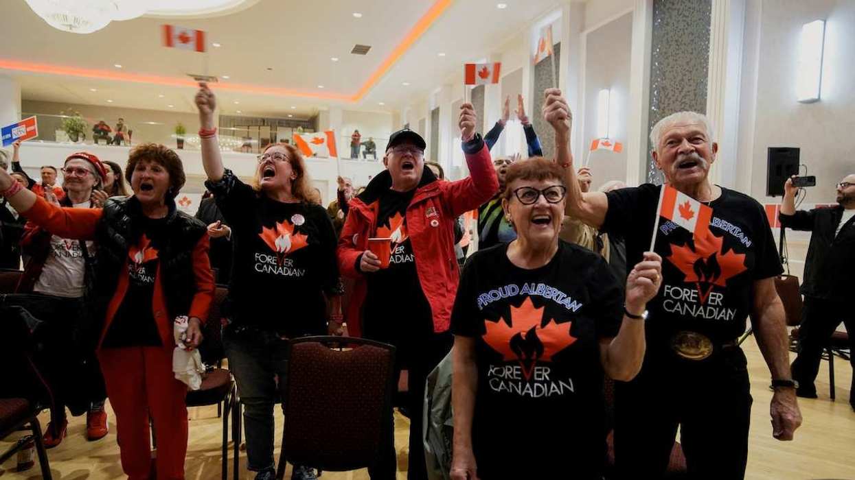 Supporters of the Forever Canadian group, who want Alberta to remain in Canada, wave Canadian flags as they wait for the results of a non-binding referendum on Alberta sovereignty in Edmonton, Alberta, Canada October 19, 2026.