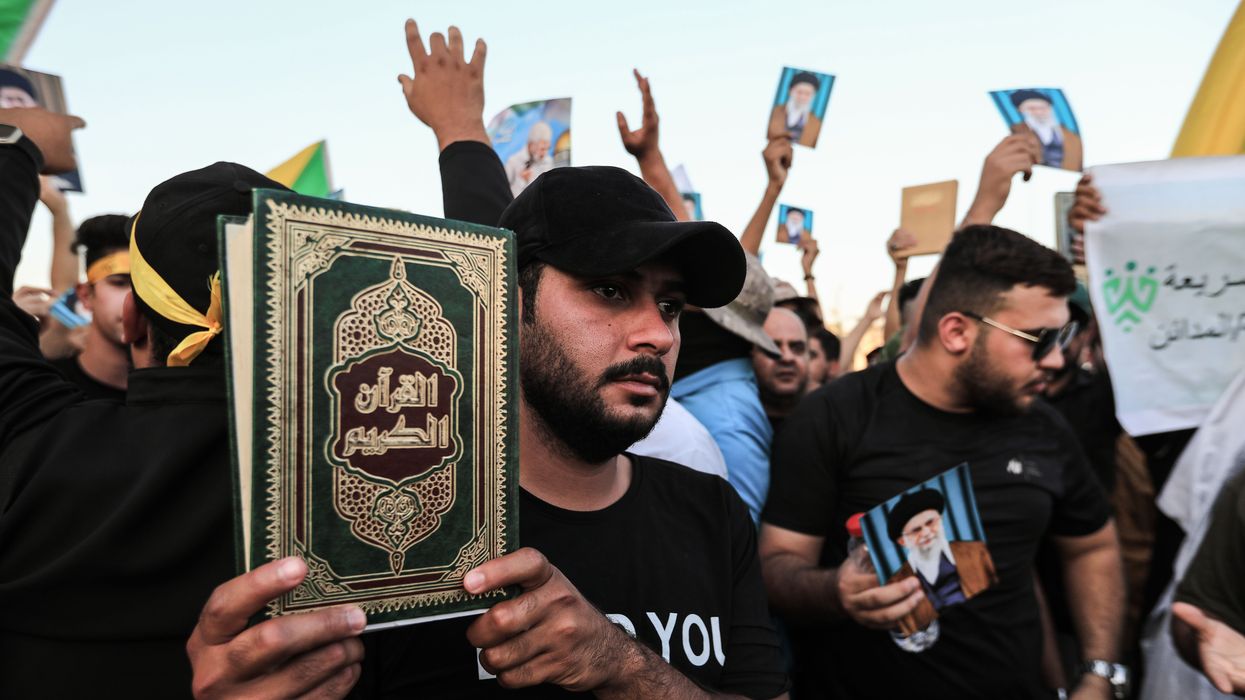 Supporters of the Popular Mobilization Forces protest in Tahrir Square in Baghdad to denounce the burning of the Quran and the Iraqi flag in Stockholm.