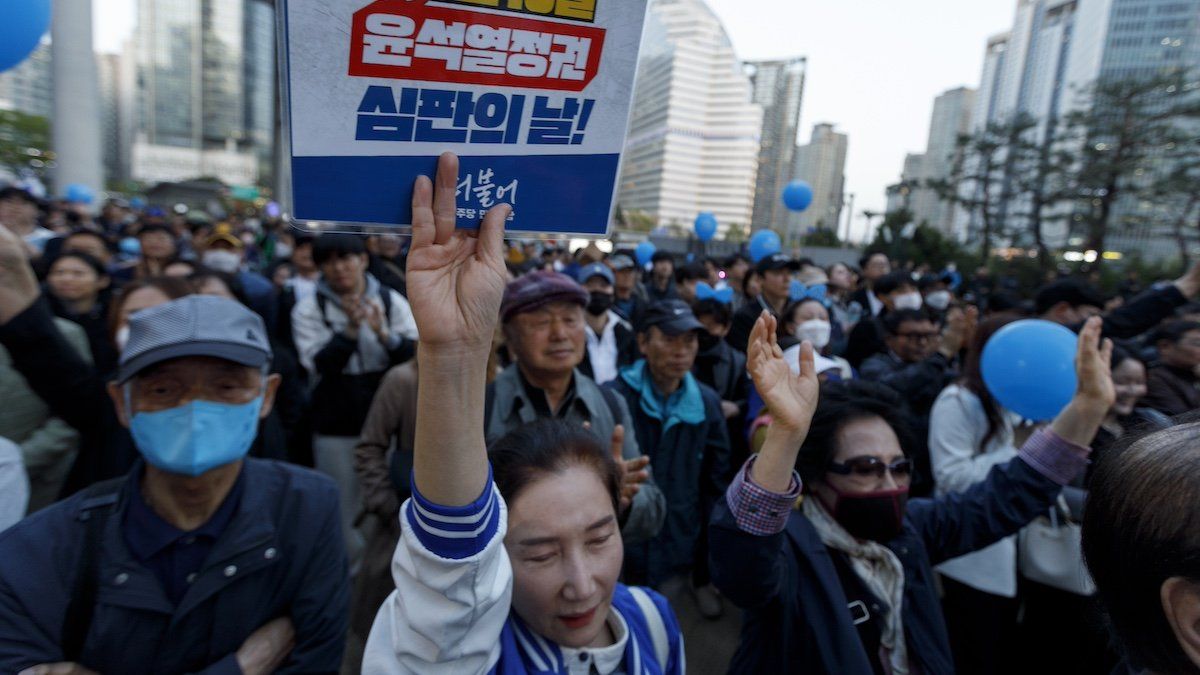 ​Supporters with a placard 'April 10 is the Yoon Suk Yeol government, Judgment Day.' attend the Democratic Party of Korea's general election campaign rally at Yongsan Station Square in Seoul, South Korea, April 9, 2024.