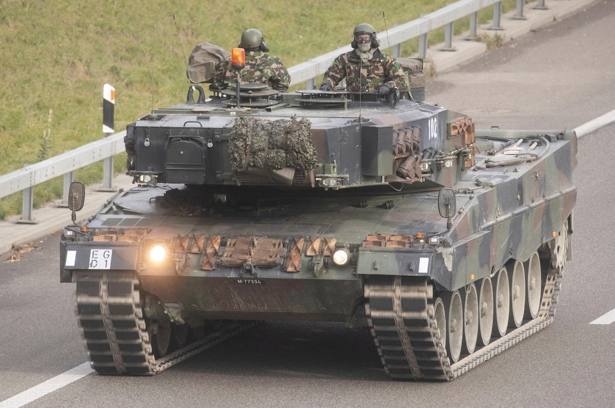Swiss soldiers on a German-made Leopard 2 tank.
