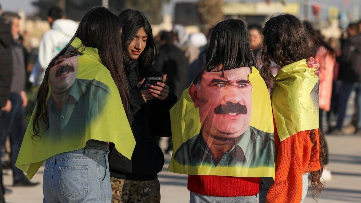 Syrian Kurds gather with flags