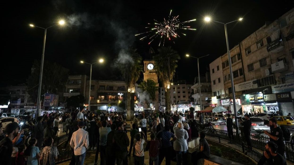 Syrians set off fireworks during celebrations in Clock Square in the center of Idlib city, after US President Donald Trump's decision to lift sanctions on Syria.
