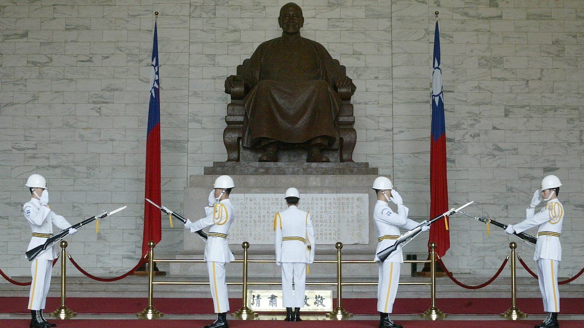 ​Taiwan honour guards march in front of a statue of Chinese Nationalist Generalissimo Chiang Kai-shek at a changing of the guards ceremony on October 27, 2003. Chiang's widow, Soong May-ling, died aged 106 in New York last week. Family members are considering whether to bury the former first lady in the United States, Taiwan or China. 