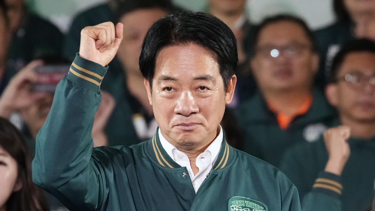 Taiwan's Vice President Lai Ching-te, who heads the ruling Democratic Progressive Party, raises his fist after winning the presidential election in Taipei on Jan. 13, 2024.