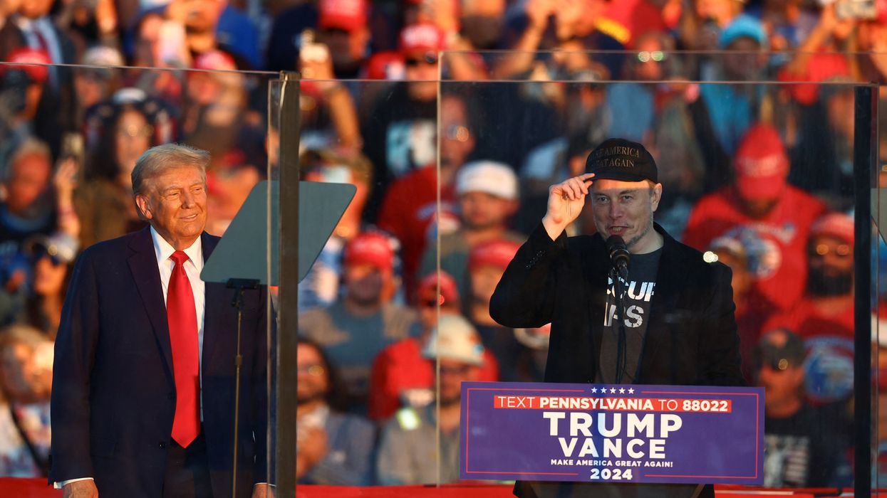 Tesla CEO and X owner Elon Musk speaks as Republican presidential nominee and former U.S. president Donald Trump looks on during a rally at the site of the July assassination attempt against Trump, in Butler, Pennsylvania, U.S., October 5, 2024.