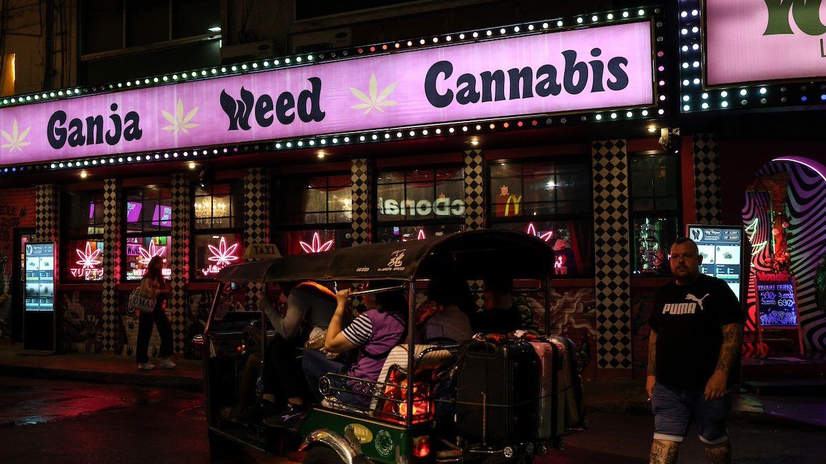 Thailand, Bangkok, 2024/01/17. A tuktuk drives past a cannabis dispensary in the Nana district.
