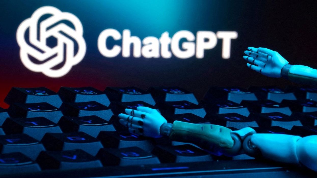 The ChatGPT logo, a keyboard, and robot hands are seen in this illustration.