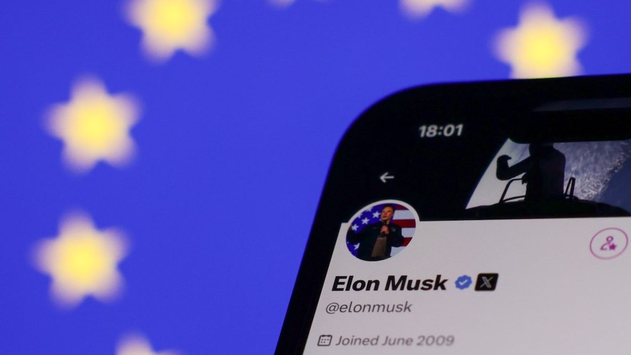 The European Union flag is displayed on a laptop screen and Elon Musk's account on X is displayed on a phone screen.