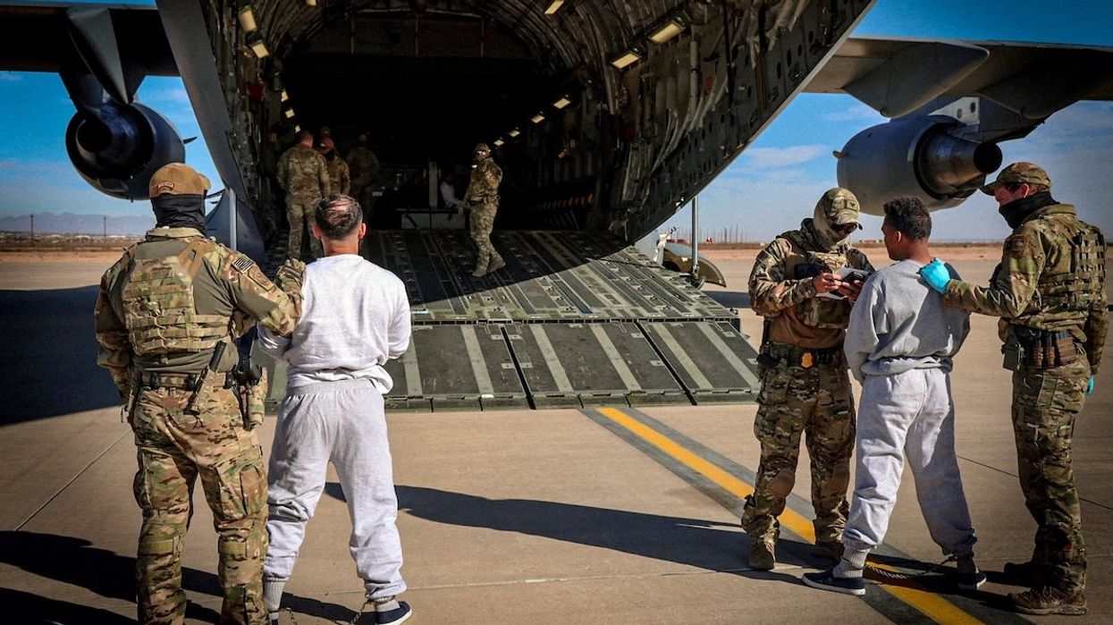 The first U.S. military aircraft to carry detained migrants to a detention facility at Guantánamo Bay, who Department of Homeland Security spokesperson Tricia McLaughlin called "highly dangerous criminal aliens," is boarded from an unspecified location on Feb. 4, 2025.