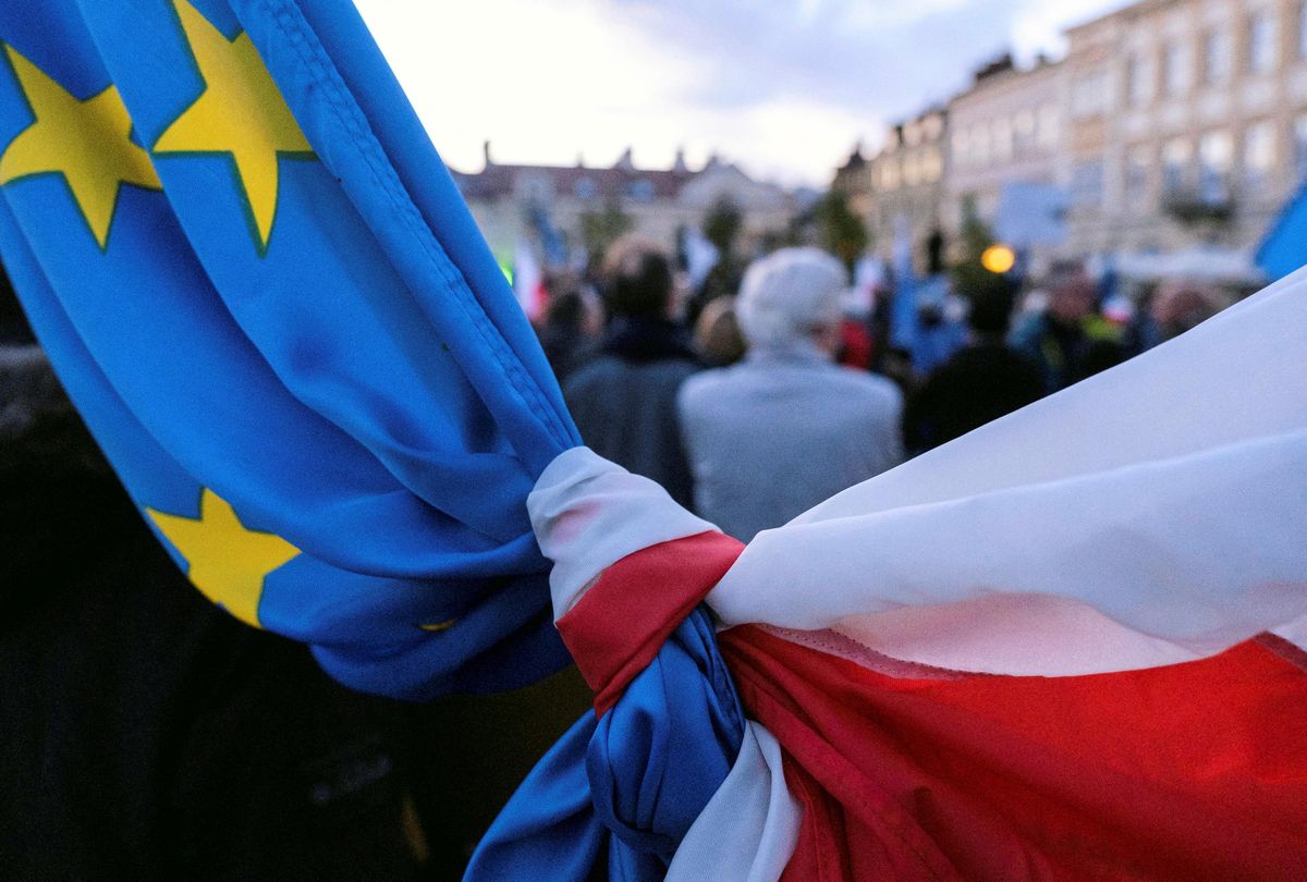 The flags of Poland and European Union are tied together during a rally in support of Poland's membership in the European Union after the country's Constitutional Tribunal ruled on the primacy of the constitution over EU law, undermining a key tenet of European integration, in Rzeszow, Poland, October 10, 2021