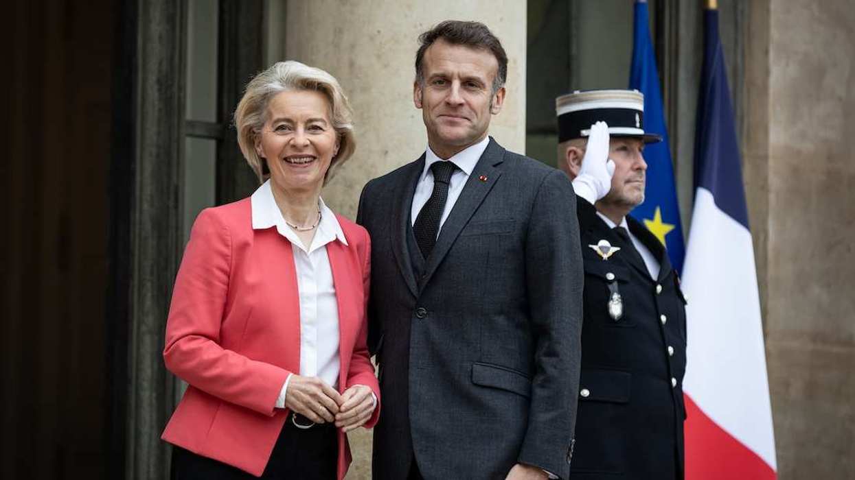 The French President Emmanuel Macron (R) welcomes the European Commission President Ursula von der Leyen (L) at the Elysee Presidential Palace.