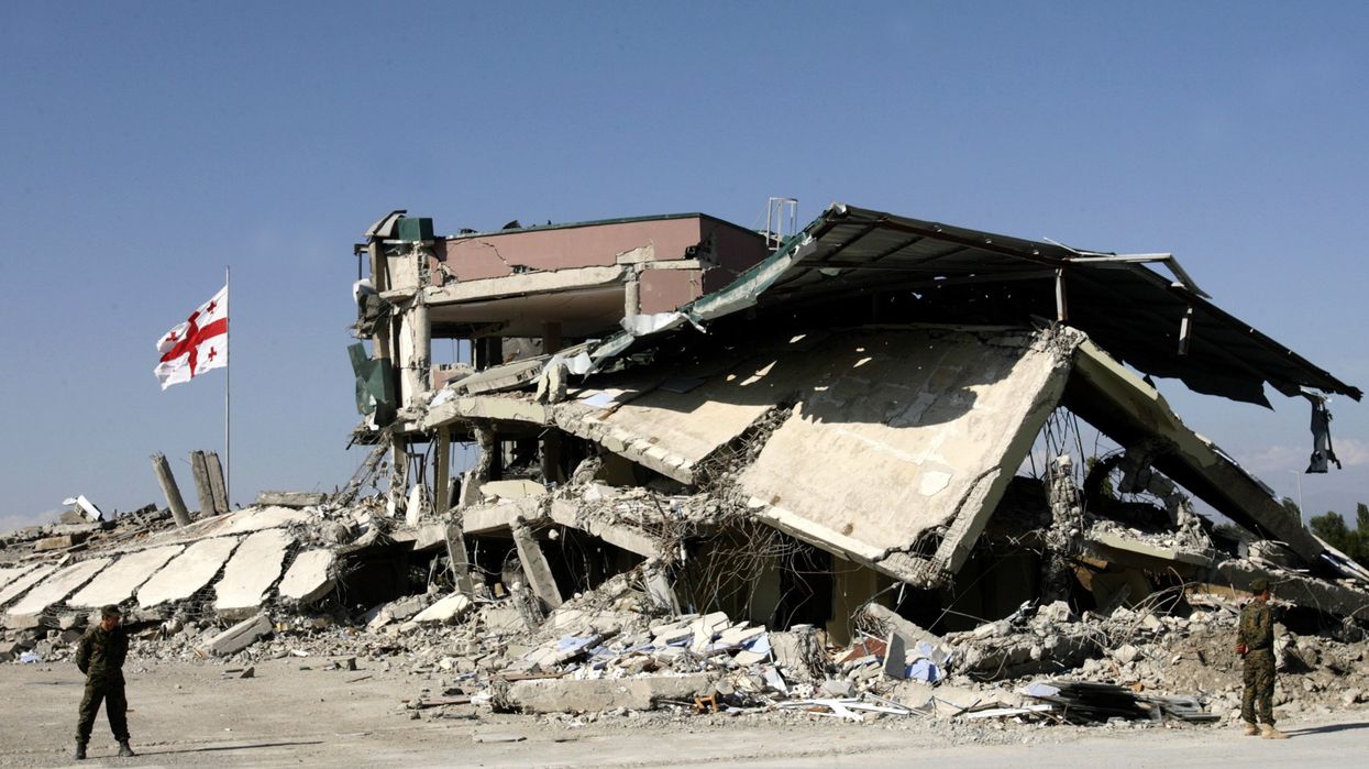 The Georgian flag flies next to a destroyed building at a military base in Gori, Georgia, on Sept. 16, 2008.
