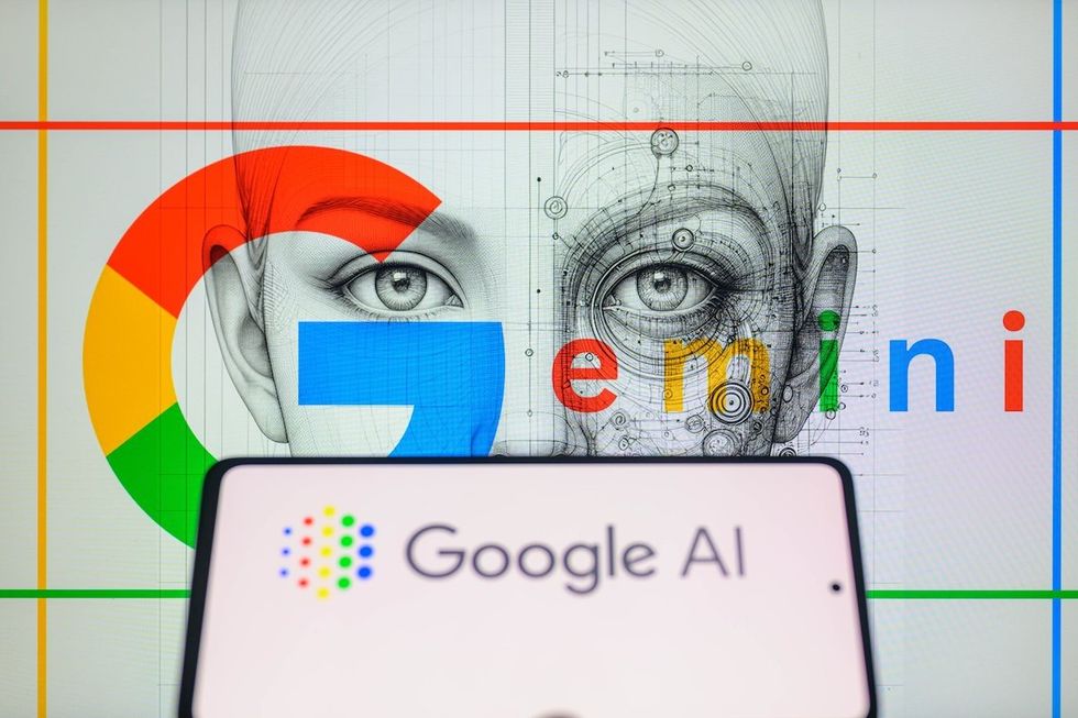 ​The Google AI logo is being displayed on a smartphone with Gemini in the background. 