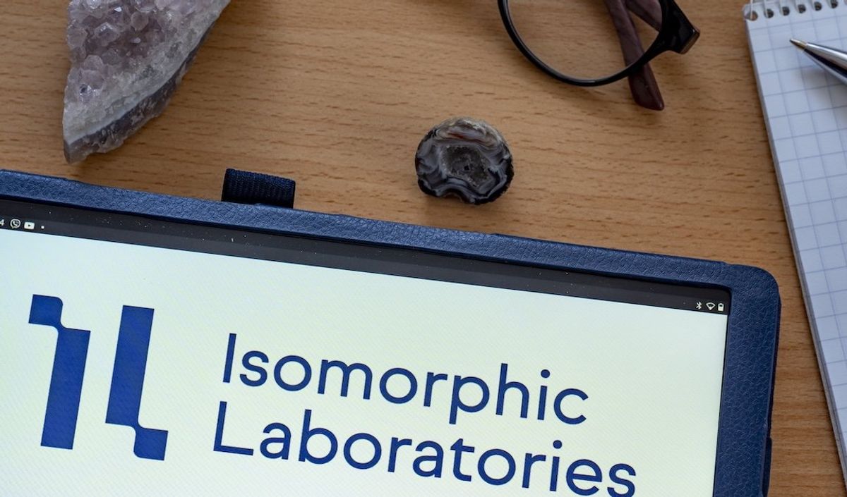 The logo for Isomorphic Labs is displayed on a tablet in this illustration.