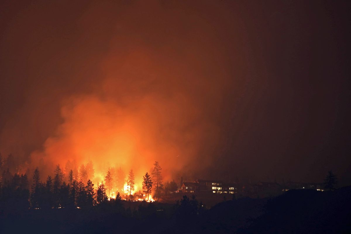 The McDougall Creek wildfire burns next to houses in the Okanagan community of West Kelowna, British Columbia, Canada.