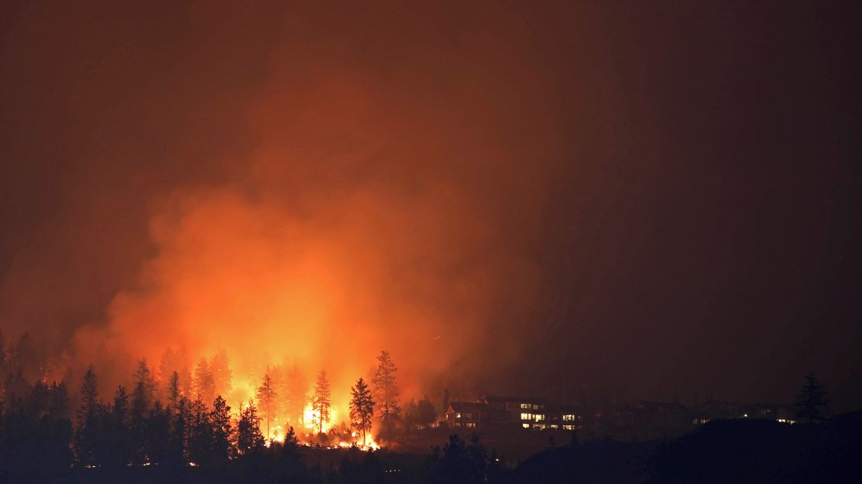 The McDougall Creek wildfire burns next to houses in the Okanagan community of West Kelowna, British Columbia, Canada.